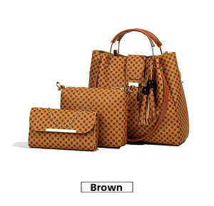 Detailed view of 3-piece brown tote set with geometric patterns and metal handles