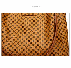 Close-up of tan tote bag material showing circular patterns and fine stitching detail