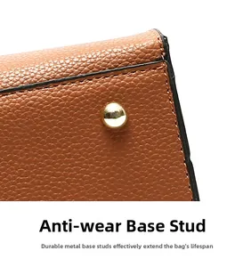 Detail of lychee textured leather bag bottom with protective gold metal base studs