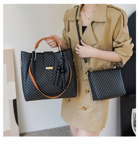 Detail of checkered tote bag and crossbody set with brown handles and tassel accent