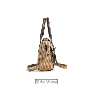 Side view of retro woven tote bag with brown leather handles and adjustable shoulder strap