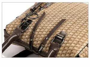 Close-up of gunmetal zipper and textured khaki woven fabric with dark brown leather trim