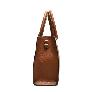 Brown lychee leather tote bag side view with gold D-ring and dual top handles