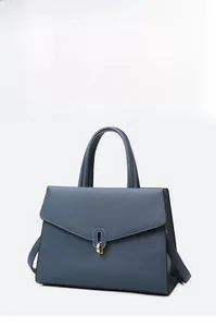 Detail of blue litchi pattern leather handbag featuring elegant gold oval twist lock closure