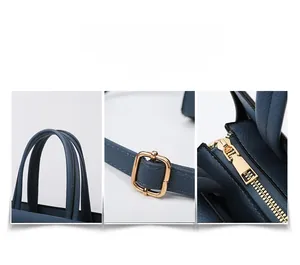 Detail of dark blue lychee pattern leather bag with reinforced handles and gold hardware