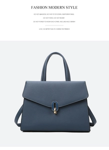 Close-up of high-quality navy blue lychee grain leather bag with golden metal buckle
