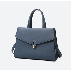 Detail of blue pebble leather handbag with envelope flap and gold hardware