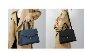 Detail of structured leather handbags with oval metal clasps in navy and black colors