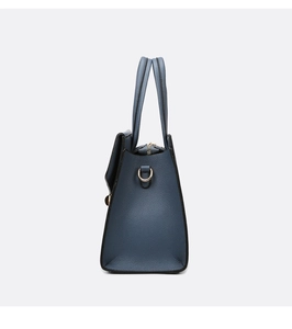 Detail of dark blue lychee pattern handbag with golden metal D-ring and zipper closure