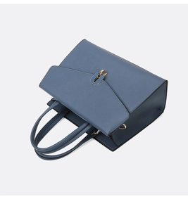 Detailed top view of a dark blue litchi pattern handbag with dual handles and gold lock