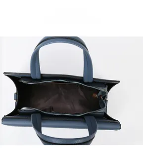 Top-down view of blue litchi pattern handbag with spacious interior and zipper pocket