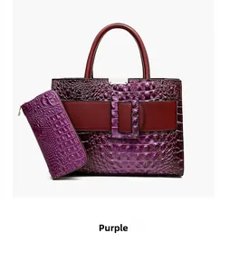 Detail of purple crocodile pattern embossed leather set with burgundy handles and metal hardware