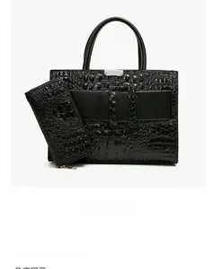 Detail view of black crocodile pattern handbag and matching long zipper wallet set