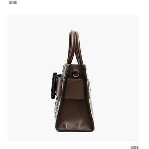 Side view of dark brown handbag showing crocodile texture and smooth leather details