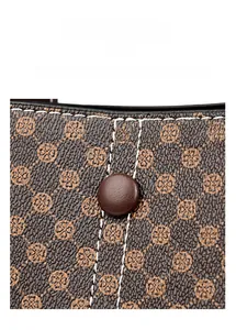 Close-up of litchi pattern leather tote bag with precise stitching and circular buckle