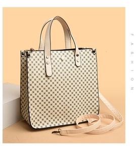 Detail of minimalist cream tote bag with black geometric patterns and dual handles