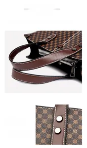 Close-up of durable brown leather straps with reinforced metal rivets on a tote bag