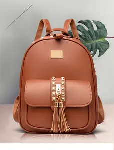 Brown PU leather backpack detail with golden pyramid studs and double tassel charms