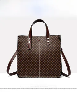 Detailed close-up of retro brown monogram pattern on a large capacity tote bag