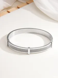 Detail of silver mesh stainless steel bracelet with three square metal accents and hidden clasp