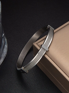 Detailed view of silver mesh textured stainless steel bracelet on a jewelry box