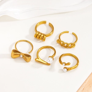 Five-piece 18k gold plated ring set with pearls and rhinestones on white texture