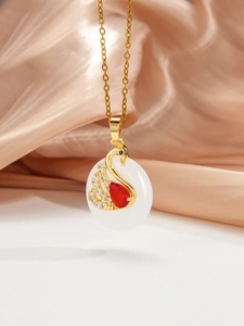 Détail du pendentif cygne avec pierre de jade blanche et accent de pierre rouge