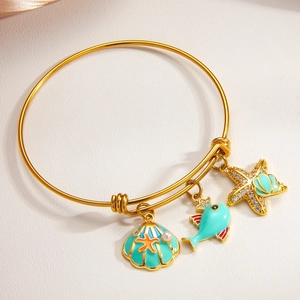 Adjustable gold marine bracelet with shell, starfish, and fish enamel charms