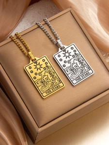 Macro detail of gold and silver tarot star pendants with intricate etched star patterns