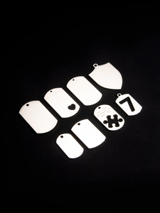 Macro view of polished stainless steel military tags and custom shape blank pendants