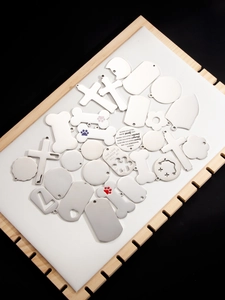 Detailed macro view of assorted stainless steel pendants with motivational engravings
