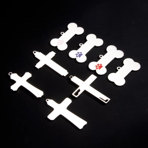 Stainless steel bone and cross pendants with colorful paw prints on black background