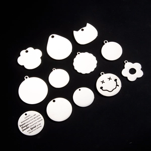 Various white stainless steel dog tags in multiple shapes with custom engraving