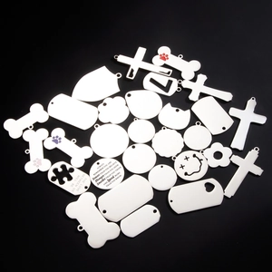 Variety of stainless steel dog tags in bone, heart, and shield shapes on black background