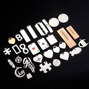 Macro detail of various stainless steel DIY jewelry pendants with custom engravings