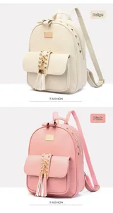 Detail view of mini PU leather backpacks in off-white and pink with studs and bow handle