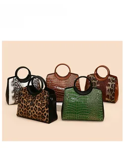Collection of retro embossed women's handbags with leopard, snake, and crocodile textures