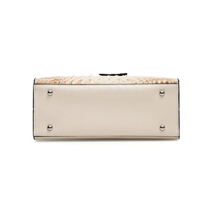 Bottom view of beige crocodile embossed handbag with silver metal protective feet