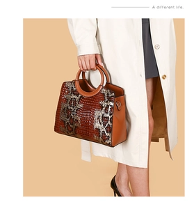 Detail of vintage brown tote with crocodile and snake skin textures for women