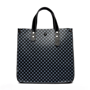 Minimalist blue geometric tote bag with black leather trim and white contrast stitching