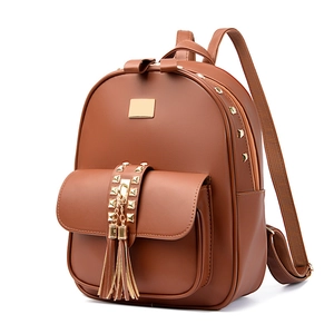 Brown faux leather backpack for women with gold rivets and tassel details on white background
