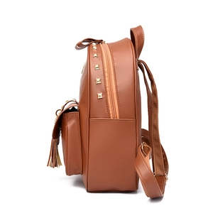 Brown leather backpack for women with gold rivet details and decorative tassel fringe