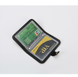 Close-up of black leather card holder with clear PVC slots for multiple cards and snap button