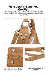 Detailed view of lychee leather bag with silver metal studs and adjustable strap