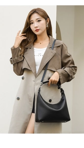 Close-up of black lychee grain leather hobo bag with silver metallic hardware details