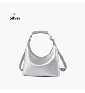 Detail view of silver hobo bag with metallic pebbled leather and knotted handle design