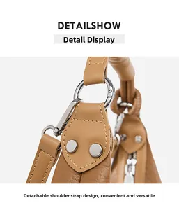 Detail of detachable shoulder strap with silver metal ring and khaki lychee leather