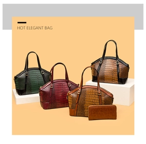 Detail of crocodile pattern leather handbags and wallets in assorted vintage colors