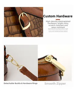 Macro shot of brown crocodile pattern leather handbag with gold-plated hardware and lock