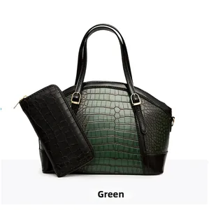 Detail of dark green crocodile embossed handbag and matching zip wallet set